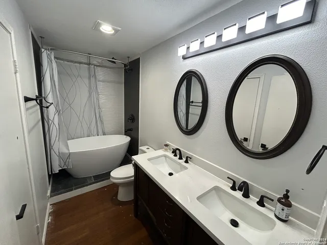 a bathroom with a toilet a sink and a mirror