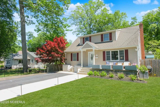 a front view of a house with a yard table and chairs