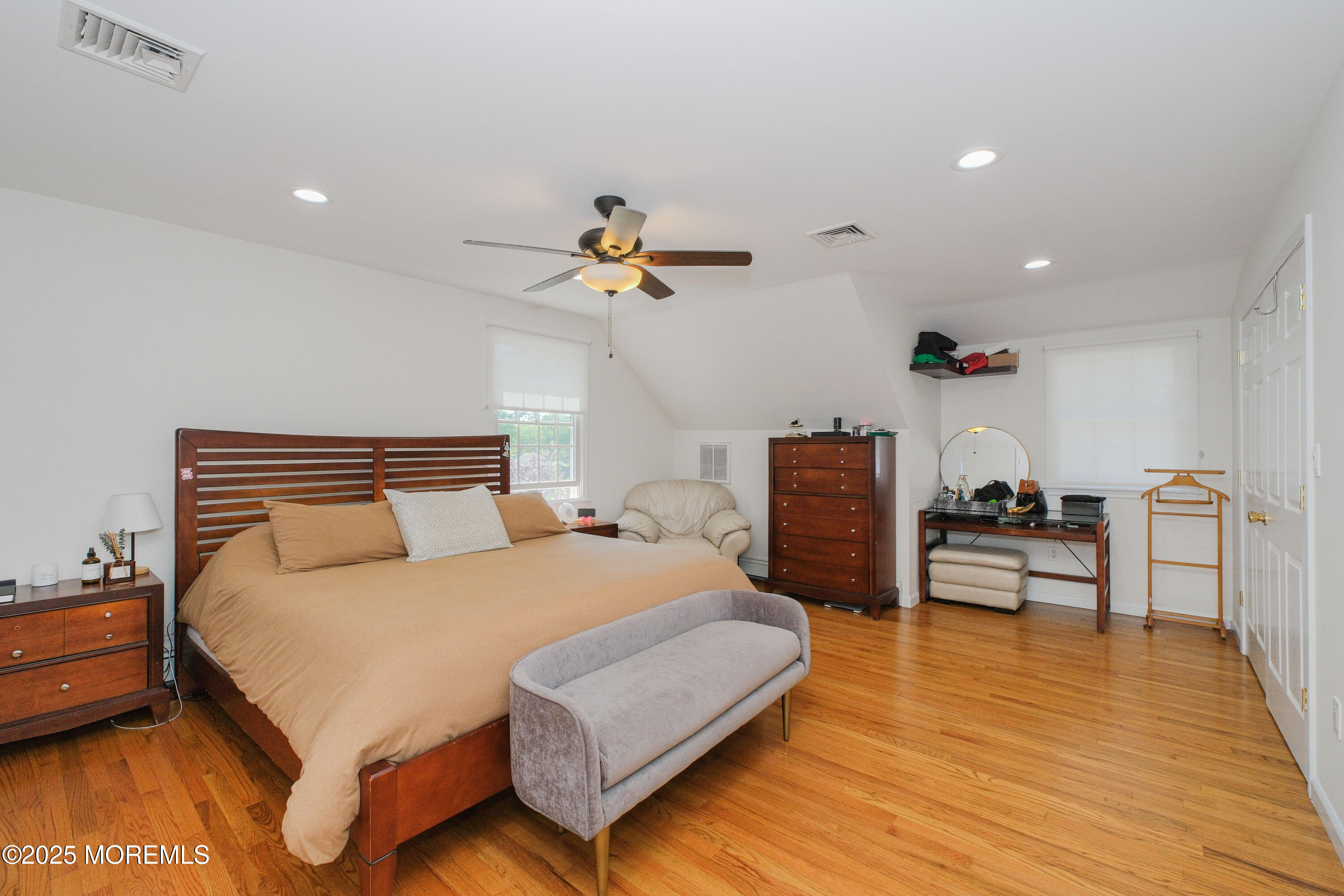 209 Woodcrest Road Oakhurst, NJ 07755 - Photo 19 of 45 a bedroom with a bed and a chandelier