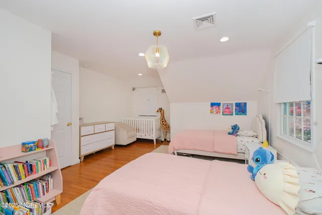a bedroom with furniture and a book shelf