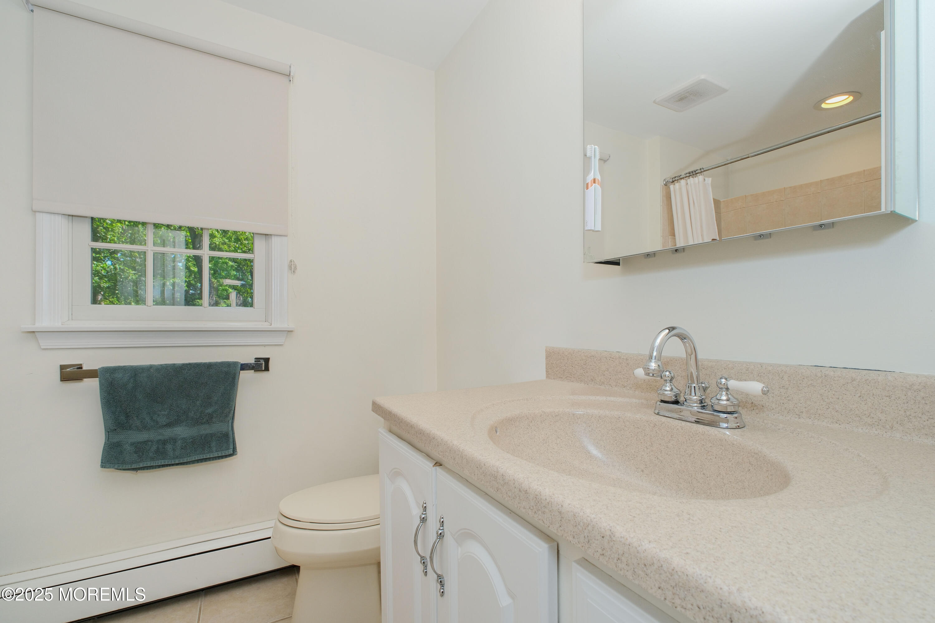 209 Woodcrest Road Oakhurst, NJ 07755 - Photo 30 of 45 a bathroom with a sink toilet and mirror