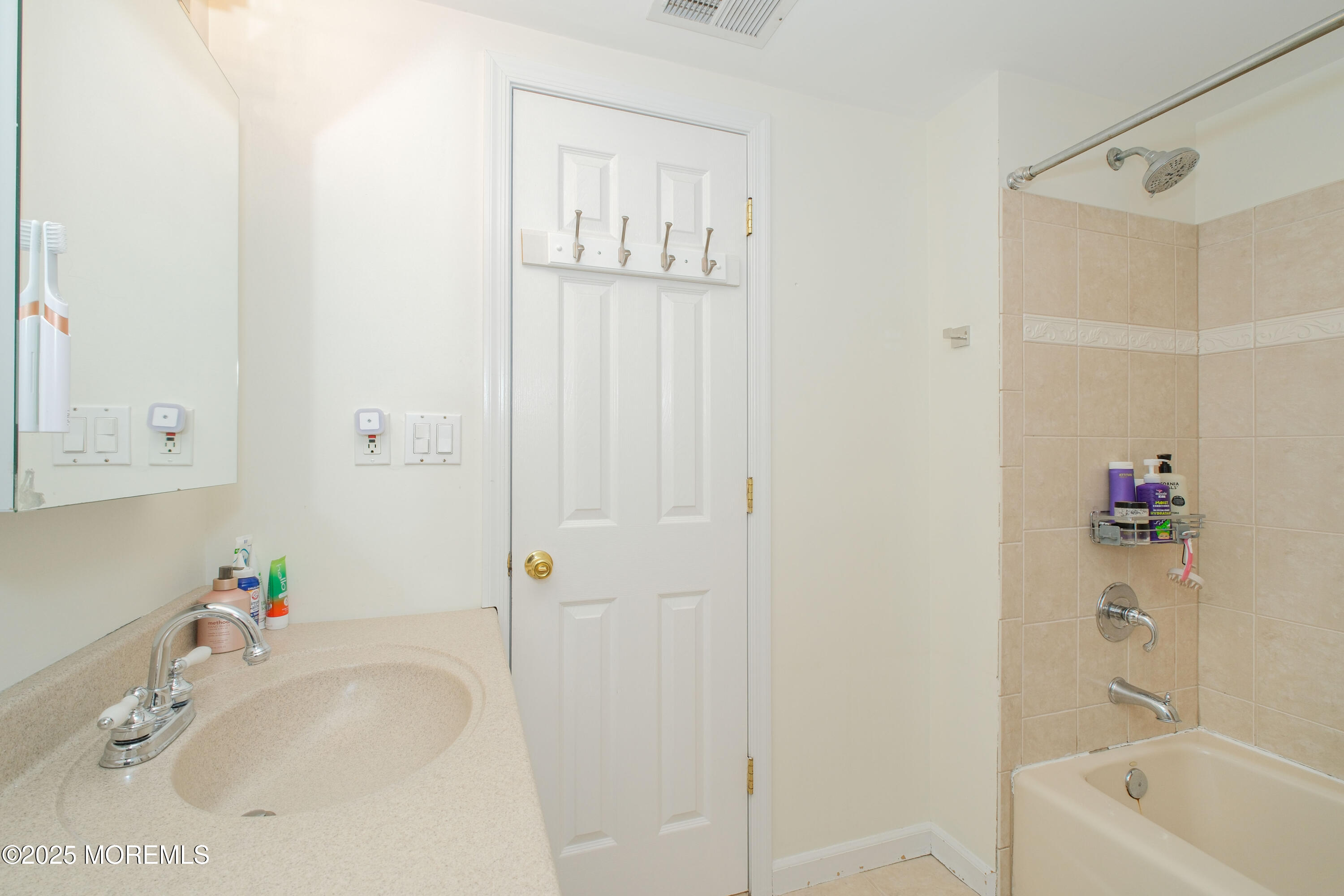 209 Woodcrest Road Oakhurst, NJ 07755 - Photo 31 of 45 a bathroom with a tub shower vanity and a sink