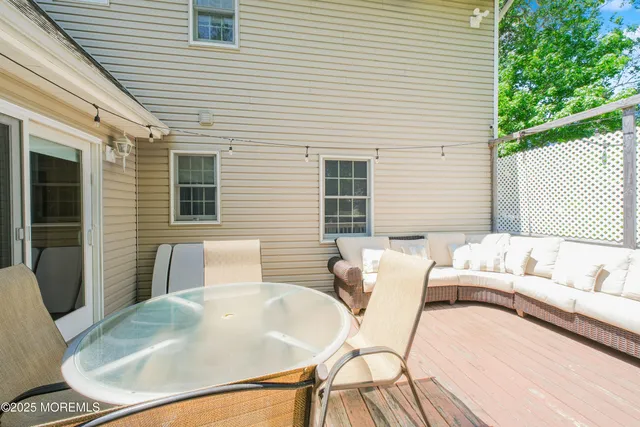 a roof deck with couch and chairs