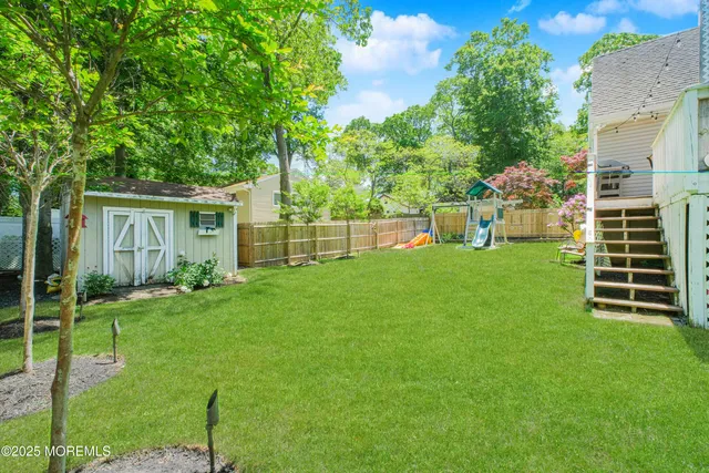 a backyard of a house with table and chairs