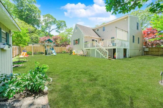 a view of a house with a big yard and potted plants