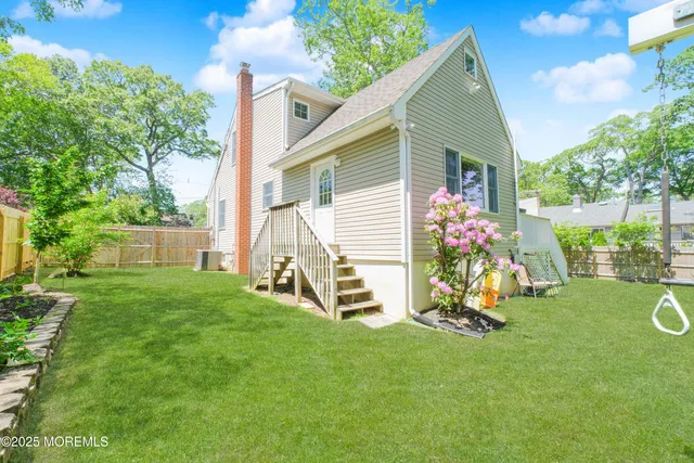 a front view of a house with a yard and a fence