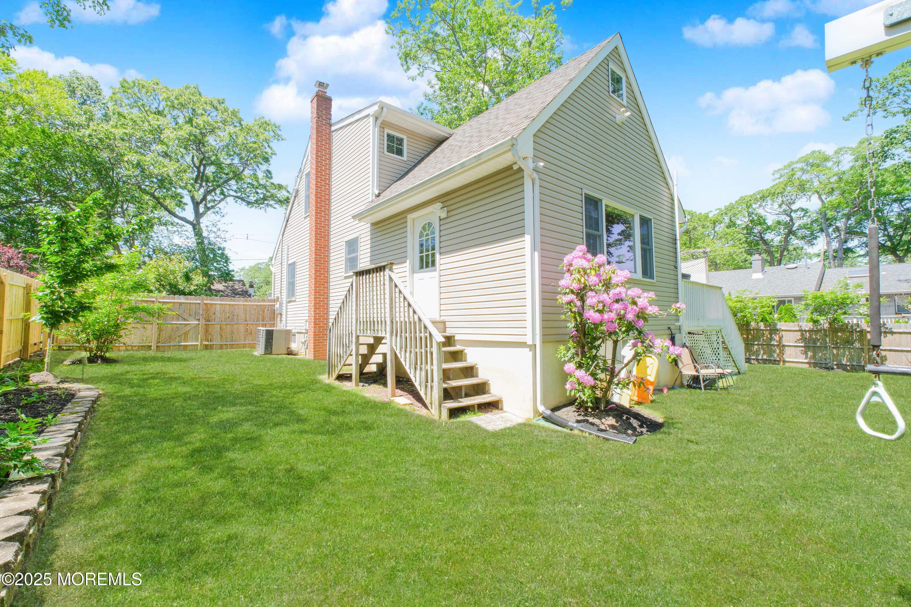 209 Woodcrest Road Oakhurst, NJ 07755 - Photo 40 of 45 a front view of a house with a yard and a fence