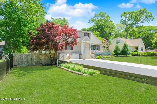 a front view of a house with a yard table and chairs