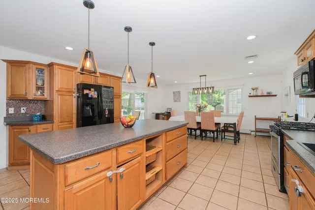 a kitchen with stainless steel appliances granite countertop sink stove and cabinets