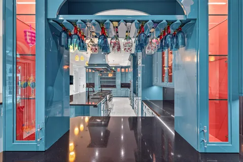 a spacious bedroom with a bed and a chandelier