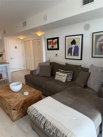 a kitchen with stainless steel appliances a dining table and chairs