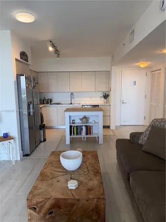 a kitchen with refrigerator and sink