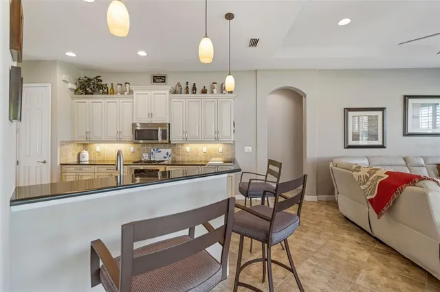 a large kitchen with a table and chairs