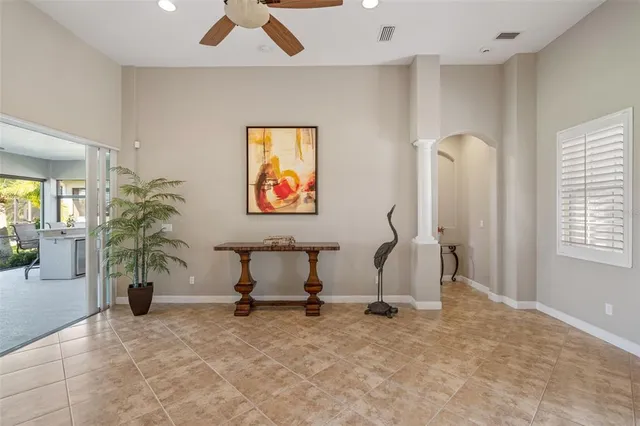 a living room with furniture and a potted plant