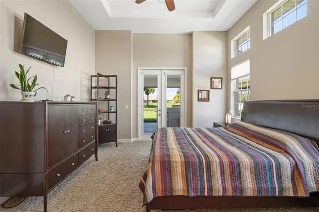 a bedroom with a bed and flat screen tv