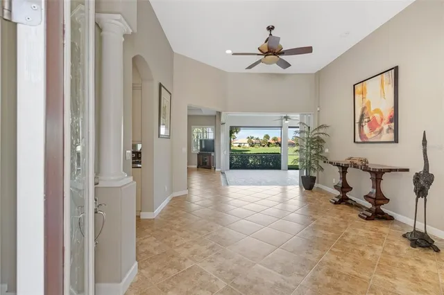a view of a hallway with a furniture and a ceiling fan