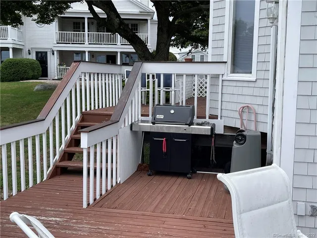 a view of a deck with barbeque grill and wooden floor