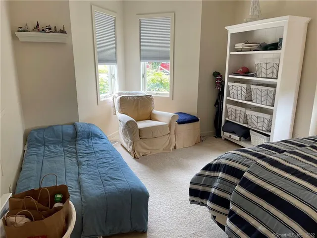 a bedroom with furniture and a window