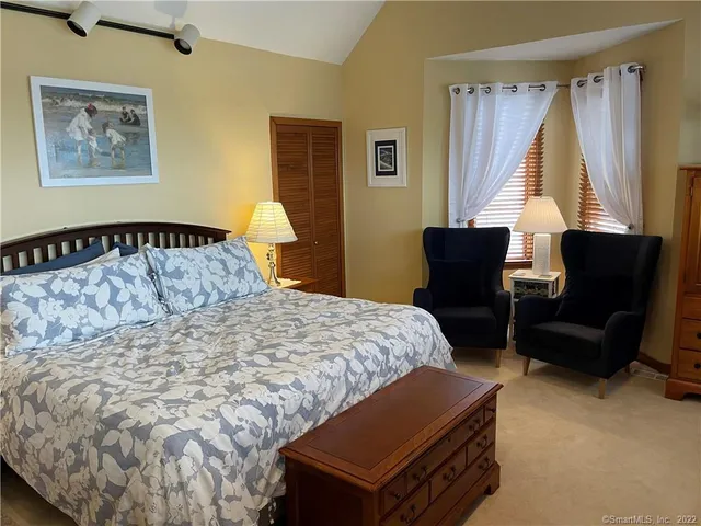 a bed sitting in a bedroom next to a window