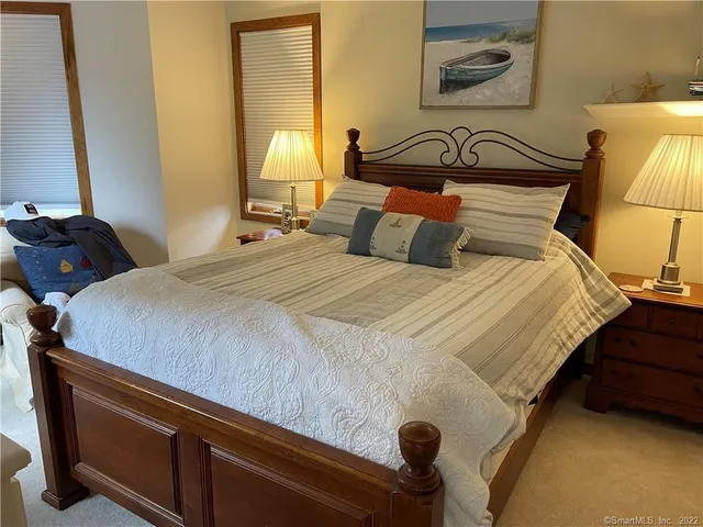 a bedroom with bed and window