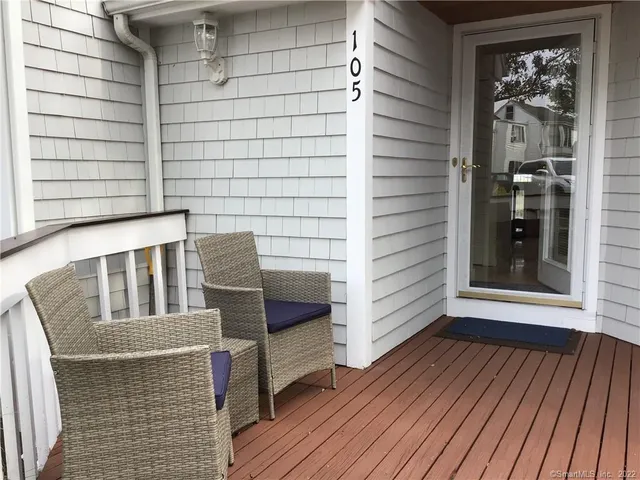 a balcony with table and chairs