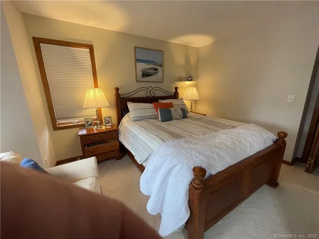 a bedroom with a bed and a night stand