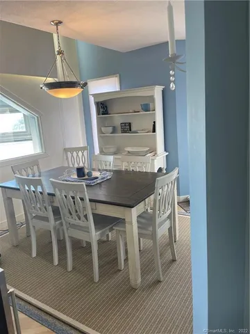 a dining room with furniture and wooden floor