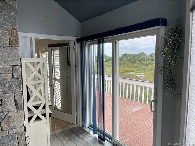 a view of a balcony with wooden floor