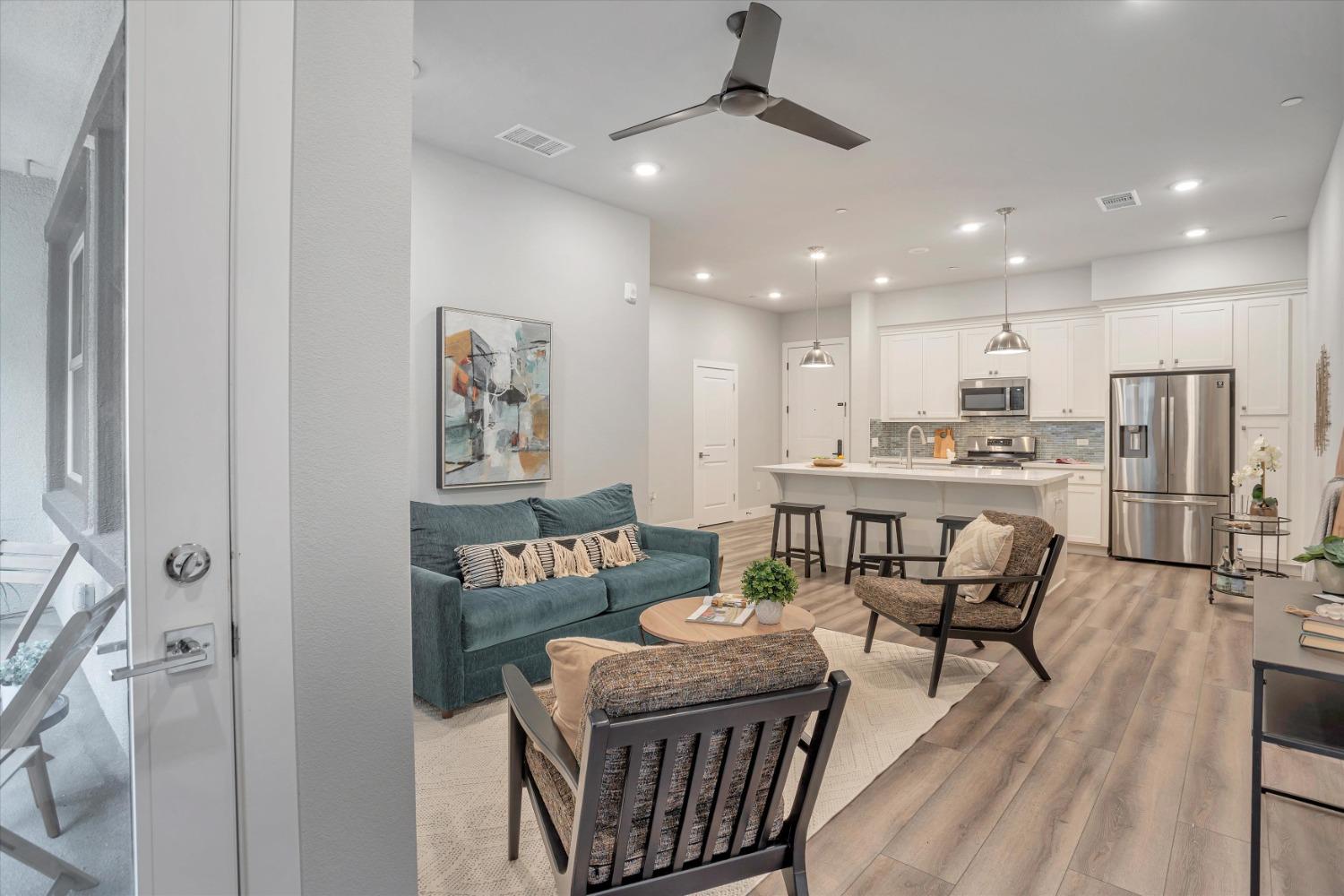 a kitchen with a dining table chairs stainless steel appliances and cabinets