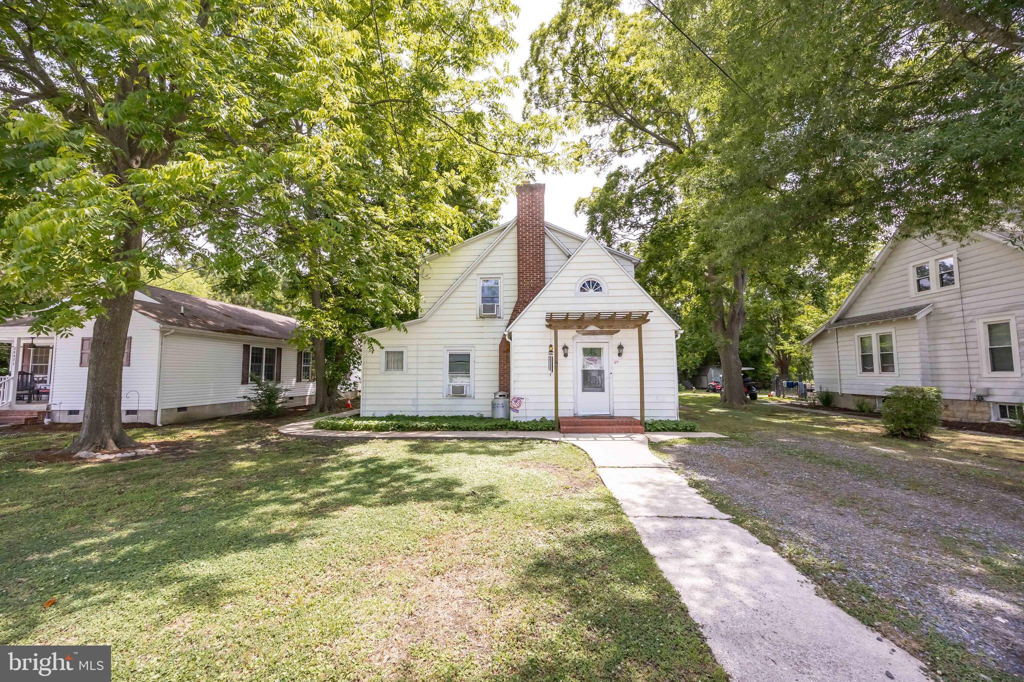 26467 Mariners Road Crisfield, MD 21817 - Photo 1 of 44 a front view of a house with a yard and garage