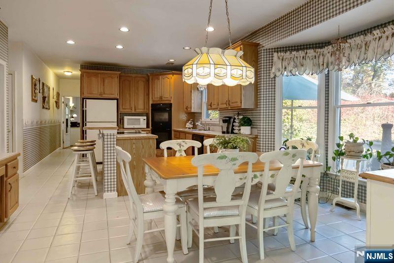 2 Upper Lake Road Oak Ridge, NJ 07438 - Photo 15 of 50 a large kitchen with a table and chairs