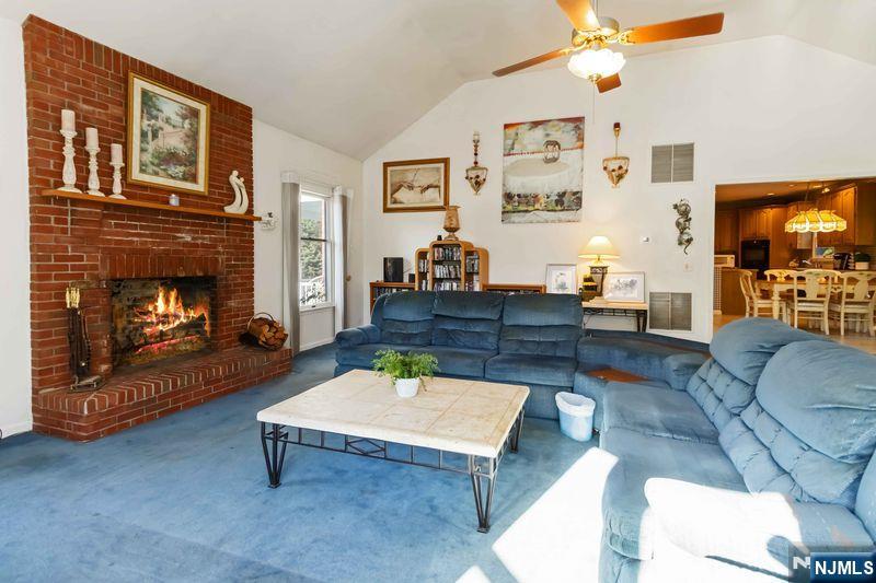 2 Upper Lake Road Oak Ridge, NJ 07438 - Photo 16 of 50 a living room with furniture and a fireplace