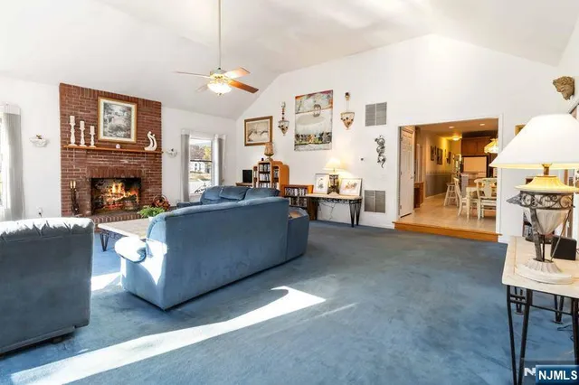 a view of a livingroom with workspace and a window
