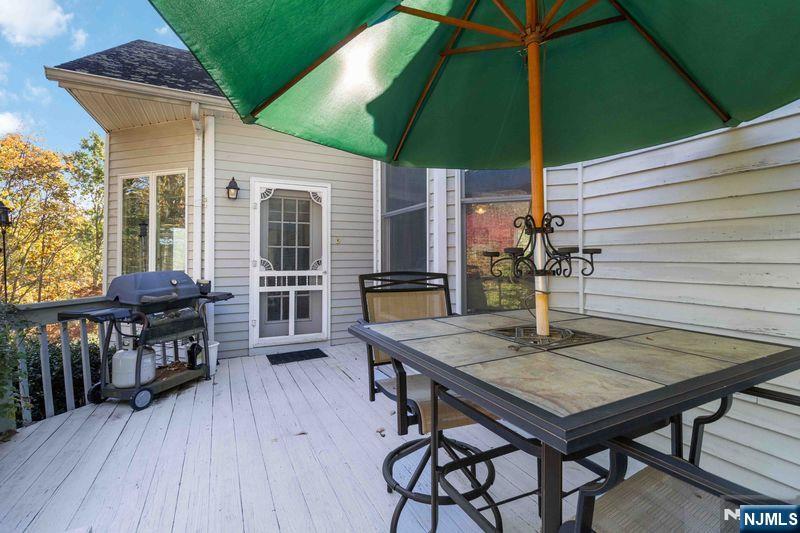 2 Upper Lake Road Oak Ridge, NJ 07438 - Photo 23 of 50 a view of backyard with a table and chairs under an umbrella