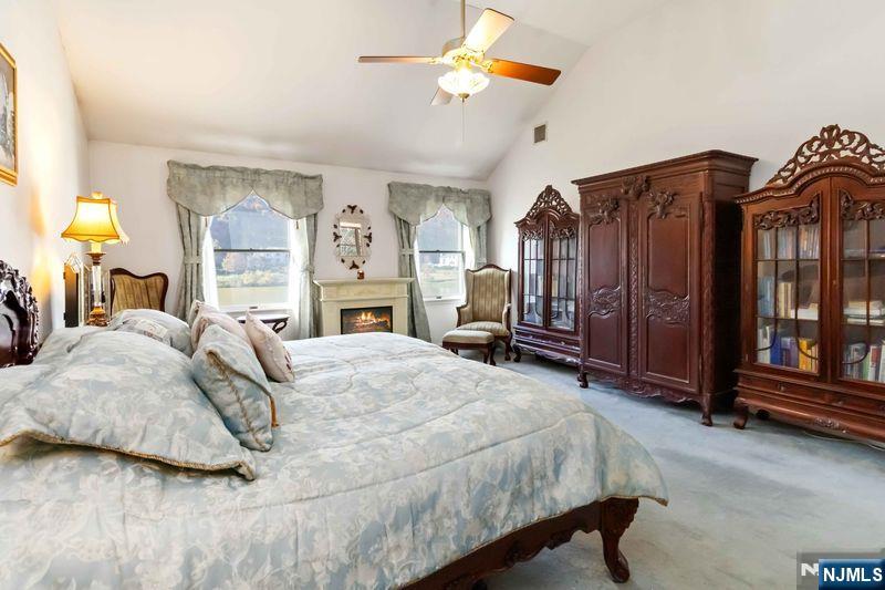 2 Upper Lake Road Oak Ridge, NJ 07438 - Photo 27 of 50 a spacious bedroom with a bed dresser and a window