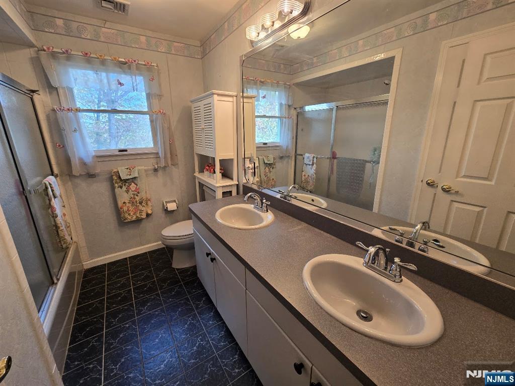 2 Upper Lake Road Oak Ridge, NJ 07438 - Photo 31 of 50 a bathroom with a sink double vanity and a mirror