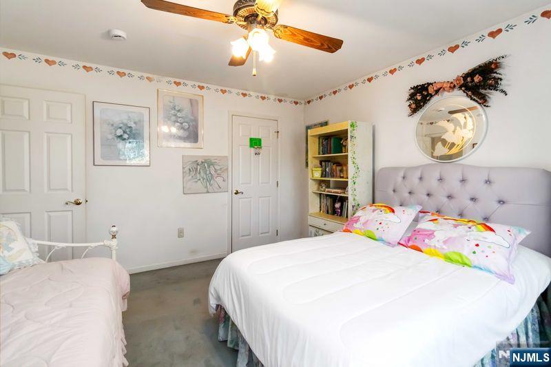 2 Upper Lake Road Oak Ridge, NJ 07438 - Photo 33 of 50 a bedroom with a bed and a chandelier