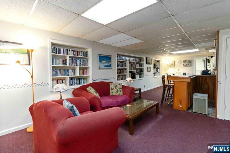 2 Upper Lake Road Oak Ridge, NJ 07438 - Photo 36 of 50 a living room with furniture and a large window
