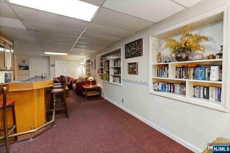 2 Upper Lake Road Oak Ridge, NJ 07438 - Photo 38 of 50 a living room with furniture and a book shelf