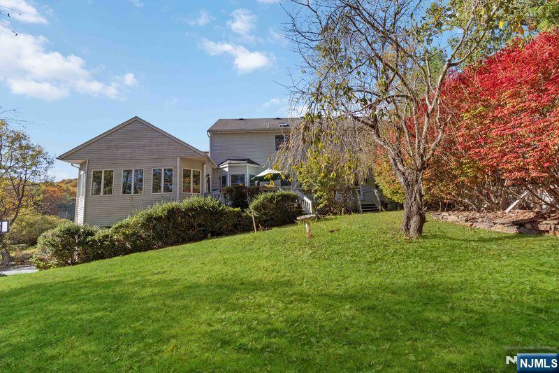 2 Upper Lake Road Oak Ridge, NJ 07438 - Photo 44 of 50 a front view of a house with garden
