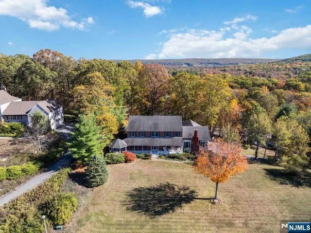 an aerial view of a house with a yard basket ball court and outdoor seating