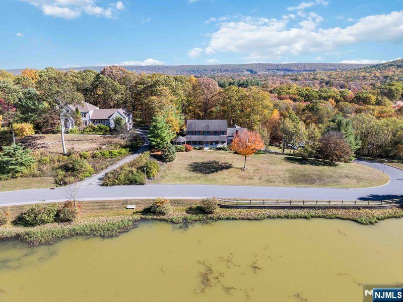 2 Upper Lake Road Oak Ridge, NJ 07438 - Photo 47 of 50 a view of a lake with a mountain in the background