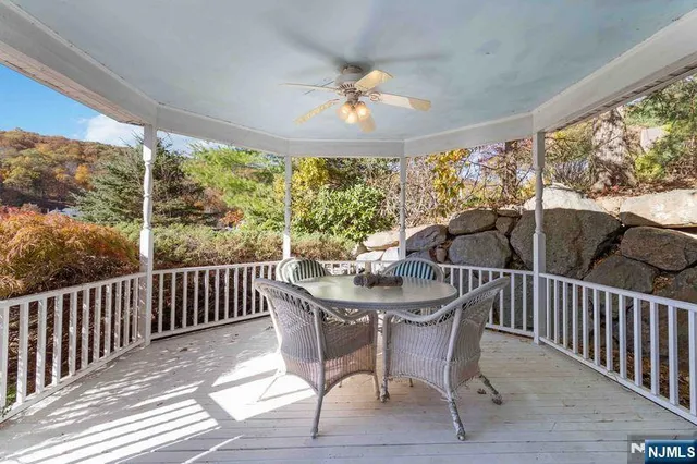 a view of a livingroom with wooden floor and a chandelier