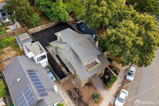 an aerial view of a house with a yard