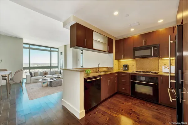 a kitchen with stainless steel appliances granite countertop a stove and a sink