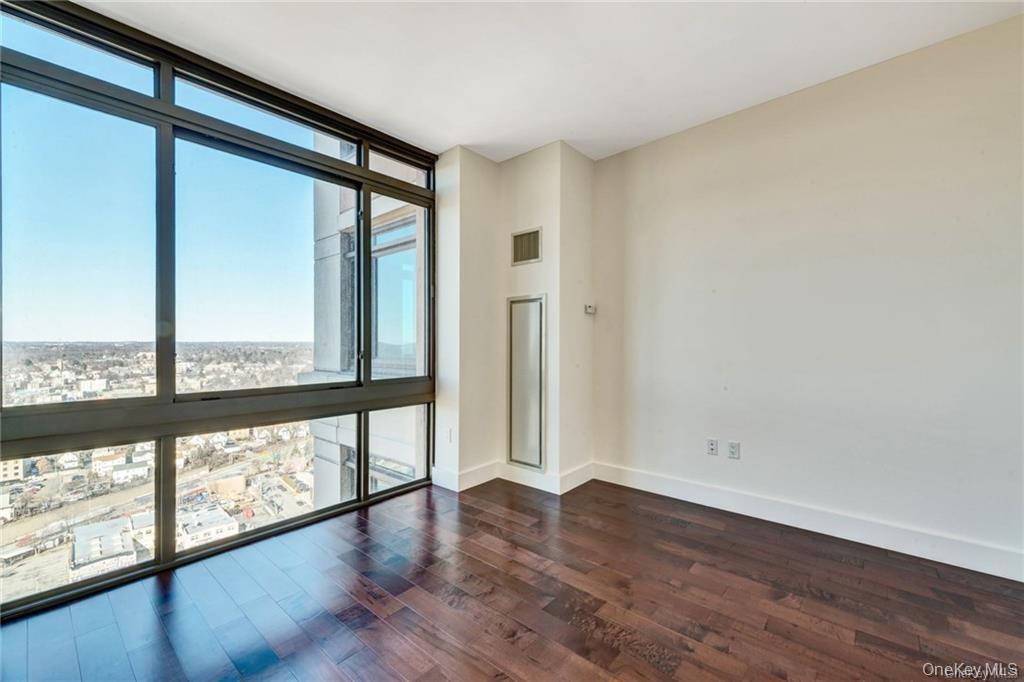 175 Huguenot Street, Unit 2404 New Rochelle, NY 10801 - Photo 6 of 8 Living room with expansive windows and dark wood finished floors