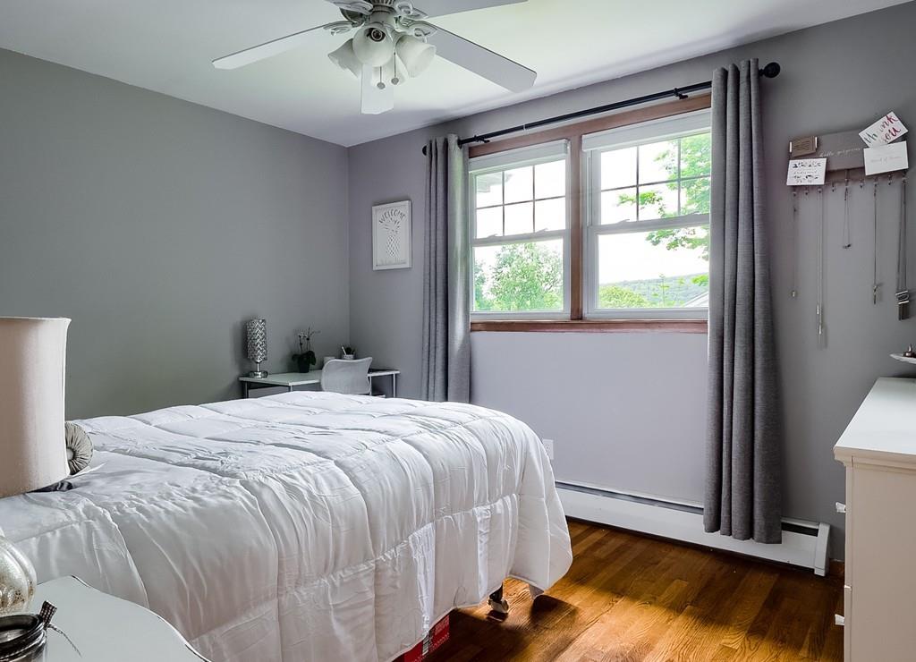 54 Manhattan Road Worcester, MA 01602 - Photo 11 of 19 a bedroom with a bed and a chandelier