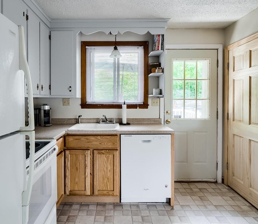 54 Manhattan Road Worcester, MA 01602 - Photo 9 of 19 a kitchen with granite countertop a sink window and cabinets