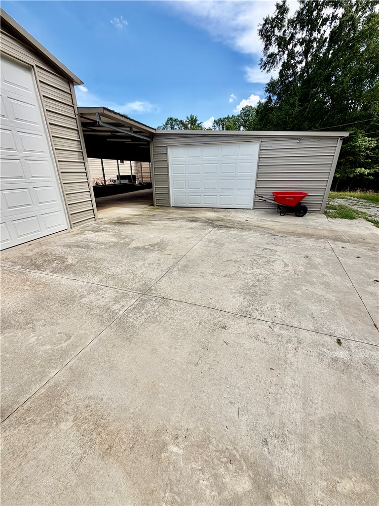 1549 Greenfield Road Westminster, SC 29693 - Photo 43 of 49 Secure storage solutions with multiple garage bays and ample concrete paving for easy access.