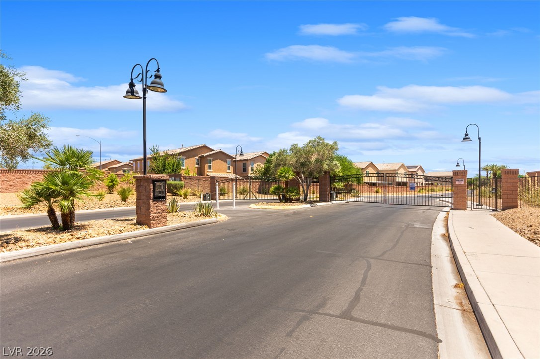 6435 Point Isabel Way Las Vegas, NV 89122 - Photo 50 of 57 Secure community entrance with an elegant wrought iron gate and attractive landscaping.